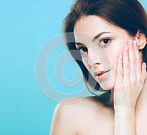 Beauty Woman face Portrait. Beautiful Spa model Girl with Perfect Fresh Clean Skin. Blue background gray