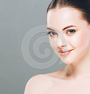 Beauty Woman face Portrait. Beautiful Spa model Girl with Perfect Fresh Clean Skin. Gray background