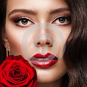 Beauty Woman Face Red Lipstick Portrait with Rose. Fashion Model Girl Red Lips Make up. Luxury Skin Care Cosmetic and Makeup