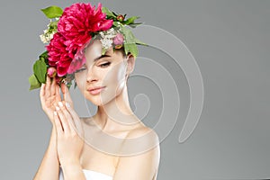 Beauty woman with flowers on head. Happy beautiful girl on gray banner background. Pretty model with clear skin. Spring fashion