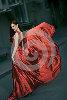 beauty woman in fluttering red dress