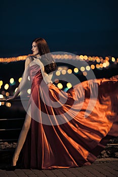 beauty woman in fluttering red dress