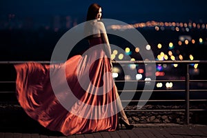 Beauty Woman In Fluttering Red Dress Outdoor