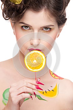 Beauty woman with fruit bodyart and juicy o