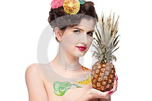 Beauty woman with fruit bodyart and pineapp