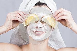Beauty woman getting facial mask. Attractive young woman with fruit mask on face at spa salon.