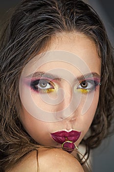 Beauty woman with glamour look, makeup and flower in purple lips. Woman with red rose in mouth, womens day. Fashion