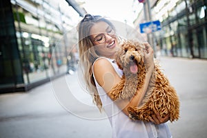 Beauty woman with her dog playing outdoors