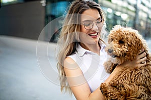 Beauty woman with her dog playing outdoors