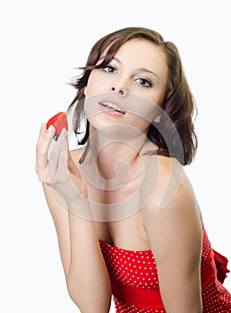 Beauty woman holding strawberry in studio, gray