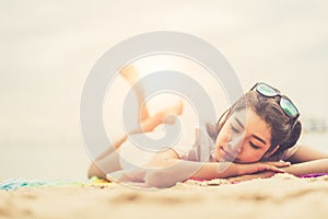 Beauty woman lying on beach. Sea and ocean background People and