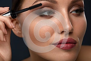 Beauty Woman Makeup. Beautiful Woman Applying Black Mascara