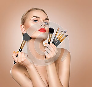 Beauty woman with makeup brushes