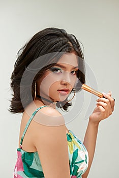 Beauty Woman with Makeup Brushes. Natural Make-up for asian Model Girl with rainbow eyeshadow.  Makeover