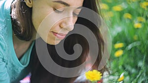 Beauty Woman in the Meadow. Beautiful Young Girl Outdoors. Enjoy Nature. Healthy Smiling Girl lying on Green Grass with