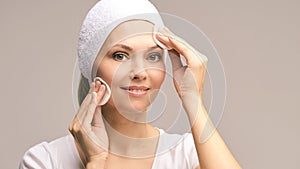 Beauty woman natural make up. Remove mascara. Cotton pad photo