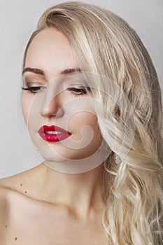 Beauty Woman with Perfect Makeup. Beautiful Professional Holiday Make-up. Red Lips and Nails. Beauty Girl`s Face isolated on Black