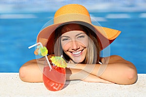 Beauty woman with perfect smile enjoying in a swimming pool on vacations