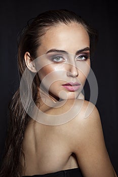 Beauty woman portrait. Beautiful spa model girl with makeup. Youth and skin care concept. Black background.