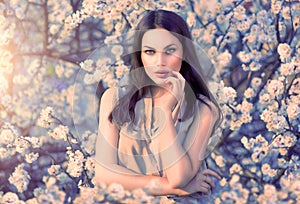 Beauty woman portrait in blooming trees