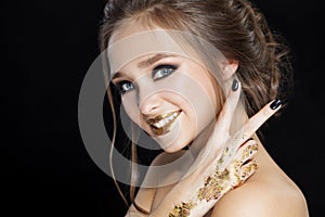 Beauty Woman Portrait. Professional Makeup and Manicure with gold foil glitter, smokey eyes. Black colors. Copy-space