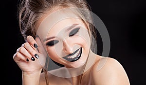 Beauty Woman Portrait. Professional Makeup and Manicure with smokey eyes. Black colors. Copy-space