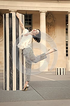 Beauty woman pose in paris, france. Beauty model pose in high heel shoes at column