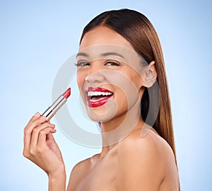 Beauty, woman and red lipstick or makeup portrait for face cosmetics in studio. Aesthetic female model on a blue