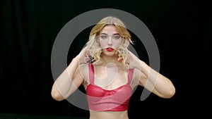 Beauty woman in red prepare hair style. Bright make up blonde looking at camera.