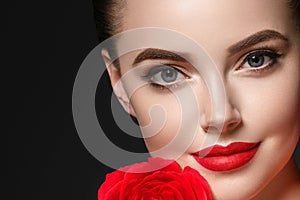 Beauty woman with rose flower beautiful curly hair and lips