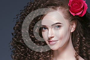 Beauty woman with rose flower beautiful curly hair and lips