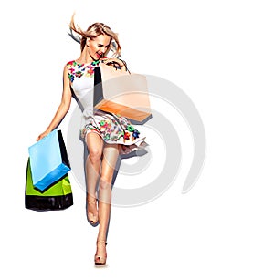 Beauty woman with shopping bags in short white dress