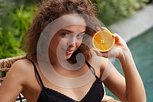 Beauty Woman. Smiling Girl With Healthy Face Skin Holding Orange in Hand