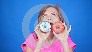 Beauty woman taking colorful donuts. Funny joyful girl with sweets