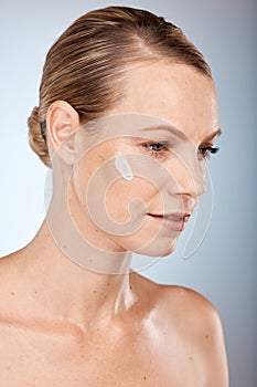 Beauty, woman and thinking with skincare cream on face for body care, health and cosmetic treatment. Natural, sunscreen