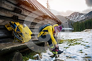 Beauty woman tourist in high mountain resort at winter wearing crampons