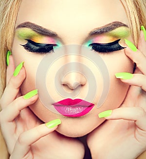 Beauty woman with vivid makeup and colorful nail polish