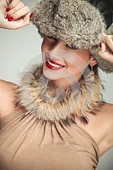 Beauty woman wearing a fur hat and smile