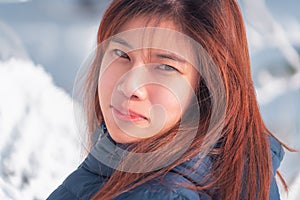 Beauty woman with winter fashion clothing with beautiful skin face in snow skii resort, closed up portrait