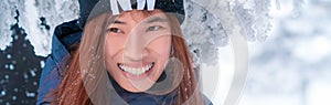Beauty woman with winter fashion clothing with beautiful smile face in snow skii resort, closed up portrait photo