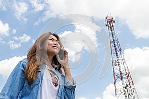 Beauty women use smart phone call and satellite communication tower