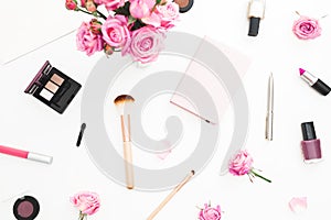 Beauty workspace with pink roses bouquet, cosmetics, diary on white background. Top view. Flat lay home feminine desk. Fashion blo