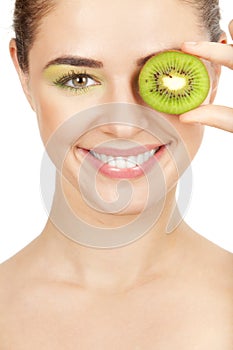 Beauty. Young beautiful woman holding kiwi