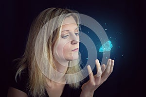 Beauty young blond hair woman hold hand under glowing blue butterfly. Photomanipulation glowing lepidopteran on black background photo