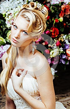 Beauty young blond woman bride alone in luxury vintage interior with a lot of flowers