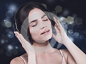 Beauty young girl hearing music with headset