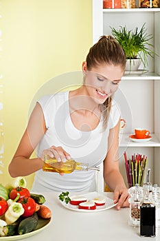 Beauty, young girl making mozarella salad photo