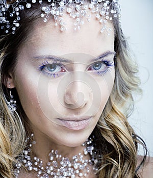 Beauty young snow queen with hair crown on her head, complicate