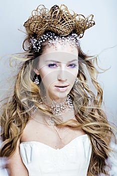 Beauty young snow queen with hair crown on her head, complicate