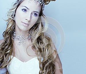 beauty young snow queen with hair crown on her head, complicate hairstyle, winter concept